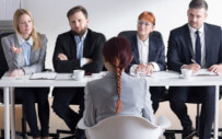 Student interviewing with group of people