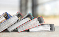 binders laying on a desk