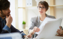 Man and woman review paperwork