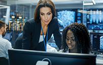 Two women working on a computer.