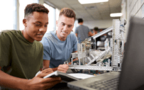 two people staring at a computer