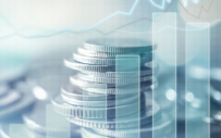 A bar chart superimposed on a photo of a stack of coins.